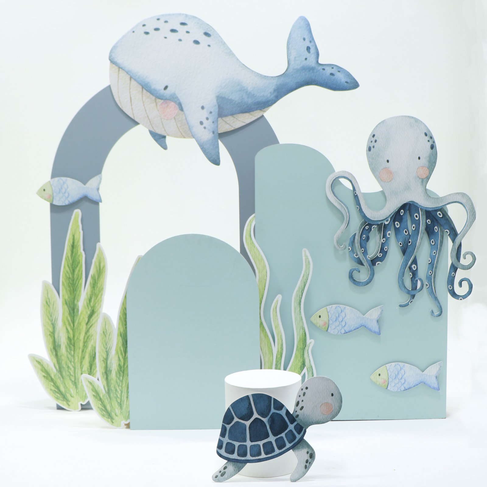 Under the Sea (1x H - 1.3m x W - .90m wavy backdrop 1x H - 1.7m x W - 1.2m hollow arch 1x H - 120cm x W - .60cm semi arch Personalization on Backdrop 1 x small circle table - white 8 x foamboard elements Personalization on Backdrop)